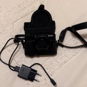Sony RX100 III - Säljer min fina Sony RX100 III kompaktkamera med Zeiss Vario-Sonnar T* lins, f1.8-2.8/8.8-25.7. Inkluderar original laddare, väska och handledsrem. Skärmen är utfällbar och kameran har inbyggd blixt. Mycket fint skick, inga defekter.💕💕 PRIS KAN DISKUTERAS VID SNABB AFFÄR