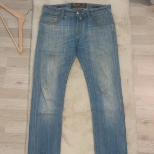 Jacob Cohen jeans - Snygga ljusblå jeansbyxor från Jacob Cohen med klassisk femficksdesign och raka ben. Jeansen har en diskret tvättad look och är tillverkade i mjukt denimtyg som ger en skön känsla. Perfekta för dig som gillar en avslappnad men stilren stil.