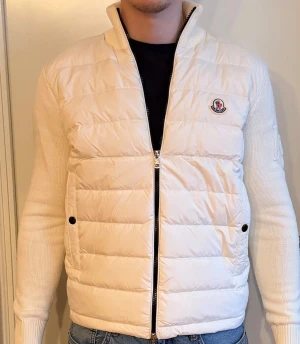 Vit cardigan från Moncler (S) tight fit - Säljer en vit oanvänd cardigan från Moncler i storlek small. Säljer jackan pga att den är för liten och för tight runt armarna. Jackan passar bäst om du är mellan 170-175cm lång samt smal (jag är 180cm lång på bilden). 