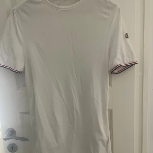 Vit t-shirt från Moncler - Vit t-shirt från Moncler i slim fit-modell. 