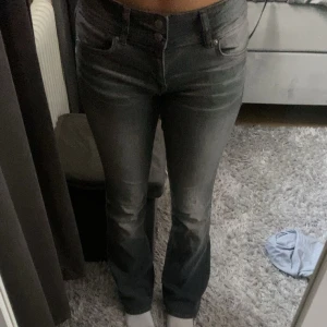 Grå bootcut jeans från Bershka - Säljer ett par gråa jeans från Bershka i storlek 36. Jeansen har bootcut-modell med lätt utsvängda ben och klassisk femficksdesign. Materialet är jeans med en snygg tvättad look och de sitter snyggt över höfterna.låg midja, knappt använda. Kan fixa mer bilder
