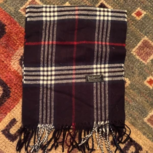 Vintage Burberry Scarf Halsduk - -Riktigt bra skick, knappt använd. Nypris på dessa ligger på runt 5000kr, vilket gör detta till ett sjukt bra pris! Halsduken är gjord i Lamull, och är perfekt inför hösten och den kommande vintern. Anledningen till att det står ”Burberry’s” och inte ”Burberry” på lappen är eftersom halsduken är från några år tillbaka, innan de bytte namn! Om du har någon fråga är det bara att skriva till mig. /elgnce (3)