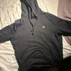 Svart lyle&scott huvtröja - En snygg och nästan oanvänd hoodie från lyle & scott som jag inte har på så ofta längre, den är XS men passar S och är perfekt för hösten och vintern nu när det börjat bli lite kallare!
