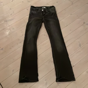 Svarta bootcut jeans Gina Tricot 158 - Svarta jeans från Gina Tricot i storlek 158. Modellen har bootcut-ben och klassiska fem fickor. Snygga slitningar och kontrastsömmar ger en cool look. Perfekta för dig som gillar en tidlös stil med lite edge.