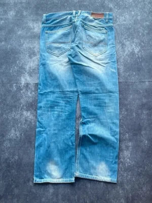 Frank Q. Denim vintagejeans för herrar i storlek W33 L32 från 2000-talet - Kunto som på bilderna & måtten finns även på bilderna! Fina detaljer och snyggt slitage!  Midja: 45 cm Benslut: 23 cm Lår: 30 cm Totallängd: 101 cm Måtten finns även på bilderna  Spara på priset och frakten genom att sätta ihop ett paket W & L är uppskattade utifrån måtten. G31