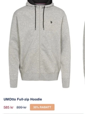 Ljusgrå zip hoodie med huva - Snygg ljusgrå hoodie med dragkedja och svart dragsko i huvan. Klassisk passform med två fickor framtill och liten broderad logga på bröstet. Perfekt för en chill och avslappnad stil. Tillverkad i mjukt sweatshirtmaterial.
