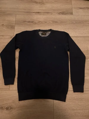 Polo Ralph Lauren tröja  - Klassisk mörkblå tröja från Polo Ralph Lauren i storleken S. Inte för tunn eller tjock passar perfekt nu mot slutet av augusti då hösten börja ta plats fram till början av vintern 
