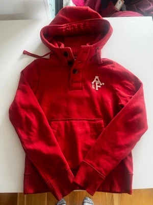 Abercrombie & fitch hoodie vintage cardigan röd vinröd - Riktigt snygg och eftertraktad Abercrombie & fitch hoodie i en riktig snygg färg. fint skick inga fel storlek L kan ta mått vid behov. Endast 395kr ej hugget i sten kom gärna med frågor och prisförslag har även mycket mer liknande i min profil alla storlekar kolla gärna stor rabatt vid köp av flera 😁✌️