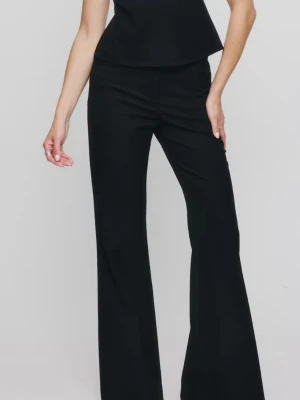 Svarta utsvängda kostymbyxor bell flare - Snygga svarta kostymbyxor med hög midja och utsvängda ben. Klassisk design som ger en clean och stilren look. Perfekta att matcha med en topp eller kavaj för en trendig outfit. Materialet ser ut att vara en mjuk och följsam mix, troligtvis polyester eller viskos.
