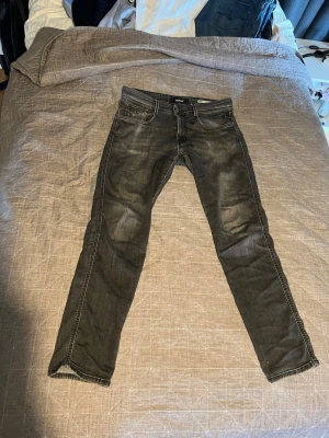 Svarta slim fit jeans - Säljer ett par svarta slim fit jeans med snygga slitningar och klassisk femficksdesign. Jeansen har normal midja och raka ben, perfekta för en avslappnad men ändå stilren look. Materialet är mjukt och stretchigt för extra komfort.