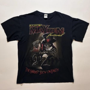Mayhem Festival 2010 T-shirt - T-shirt från Mayhem Festival 2010 där bl.a Korn, Rob Zombie, Lamb of God, Avenged Sevenfold och Five Finger Death Punch spelade.  Väldigt fint skick  100% bomull  Skicka ett meddelande om du har frågor eller vill se fler bilder 