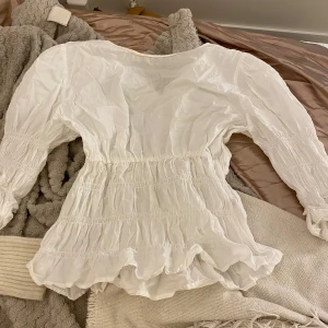 Vit topp -  Vit topp från second hand. Gullig figur sydd form. Står att den är storlek M, men jag skulle säga att den är S.   