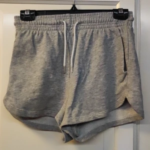 Enkla grå mjukis shorts - Enkla grå mjukis shorts, väl använda men bra skick, saknar en av metall grejerna till snöret på ena sidan men de e lugnt.