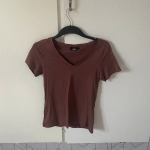 v ringad T-shirt - V ringad t-shirt som är från Lindex i färgen brun och är i nyskick