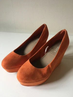 Orange platåsko - Orange platå/kilklack i mockaimitation. 