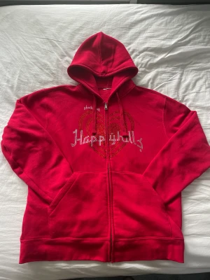 Happy Hills Rhinestone Tröja - Skit fet Happy Hills rhinestone zip som köptes för ett år sedan. Knappt använd överhuvudtaget så i väldigt bra skick. Alla stenar sitter kvar dock så är taggen på insidan avklippt✨. Är 183 och sitter bra på mig. Passar mindre och större också🤙🏼