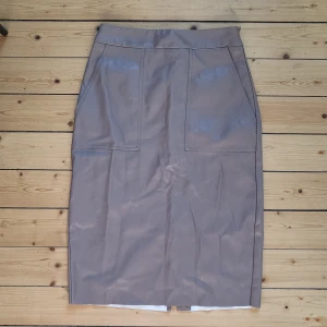 NLY Trend knee long skirt - Knee long skirt, size 36 from Nelly trend. Faux leather in light taupe/brown. Good condition 