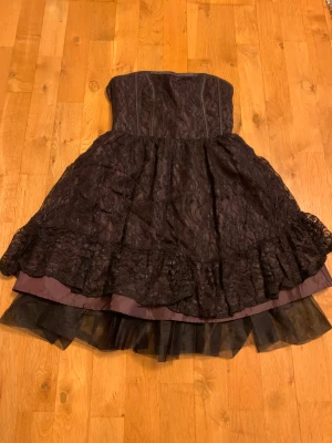 Fin festklänning i spets - Fin festklänning i spets utan axelband. Aldrig använd så är som ny. Skriv privat för fler bilder. 