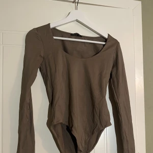 Ljusbrun body  - Säljer min ljusbruna body från Stradivarius. Är inte så strestchig men den sitter snyggt på kroppen. Är i fint skick och använt 1 gång. 
