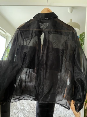 Transparent svart topp - En jättefin svart genomskinlig topp som är snygg att ha till allt. 