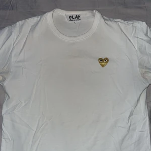 CDG T-shirt - Säljer min vita och guldiga CDG tshirt. Storlek L. Skick 9/10. Inget kvitto. Fler bilder i DM.