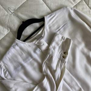 viscose off-white shirt good for a size XS/S, covered fly and nice minimal collar. 