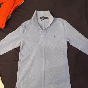 Ralp Lauren långärmad piké - Stilig längärmad Ralph Lauren pique i udda färg som inte används längre. L i barnstorlek motsvarar (XS) i vuxen