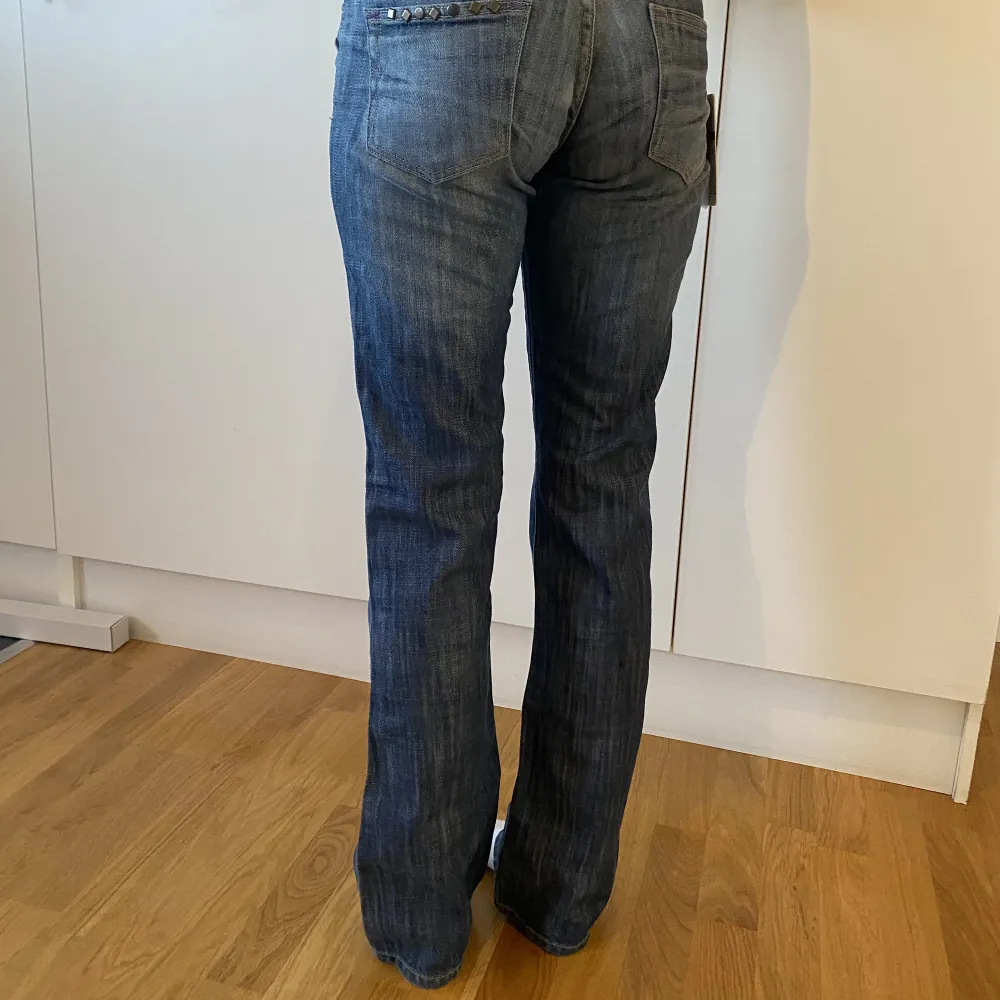 Låga bootcut jeans med så snygga detaljer. Innerben: 81cm, midjemått rakt över: 36 cm. Helt nya med lappar.. Jeans & Byxor.