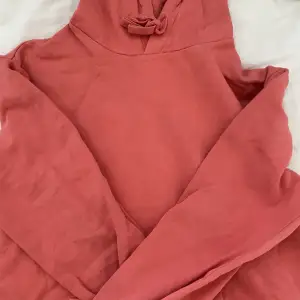 En corallrosa hoodie