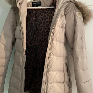 Beige hollies jacka - Säljer denna fina hollies jacka💓 har haft den i ca två vintrar, men eftersom jag mer haft den som extra jacka är den inte så använd! Storlek 32 men passar upp till 36.