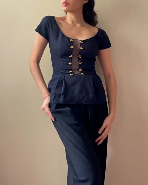 VINTAGE 90S VALENTINO NAVY WITH MESH PANEL PEPLUM TOP - Vintage 90s Valentino Silk Top with Feminine Skirted Silhouette. Middle Mesh Panel featuring Brass Adornments. Best Worn Fitted. Some handmade alterations in the Lining by previous owner, not visible when worn. Overall Great Condition. 