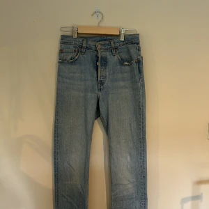 Levi’s 501 - Levi’s 501 in size 25 and 32 inseam! Minor discoloration shown in second photo. These have a store string going through the waist band as they used to be too small for me. The Levi’s logo was resewn vertically which is shown on the last photo. 99% cotton!