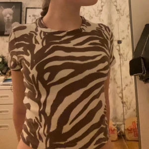 Zebramönstrad topp - En fin zebramönstarad topp i gott skick. Storlek S men passar även XS och M då det är mycket stretch i den
