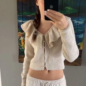 Kofta med volanger - Säljer denna jätte fina stickade koftan med volanger från hm pga att den ej kommit till användning. Koftan är i jätte fint skick då den bara har används ett fåtal gånger💗