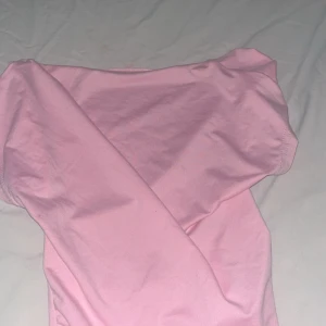 Rosa offshoulder topp från SHEIN XS - Supersöt ljusrosa offshoulder topp från SHEIN i storlek XS. Toppens material är mjukt och stretchigt, perfekt för dig som gillar en feminin och trendig look. Enkel design utan mönster, passar till många olika outfits.