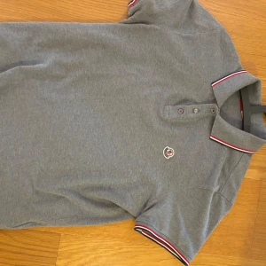 Grå pikétröja från Moncler - Moncler Pike M condition 8/10 . Äkthetbevis skickas i chatt. Kan släppa billigare vid snabb o smidig affär