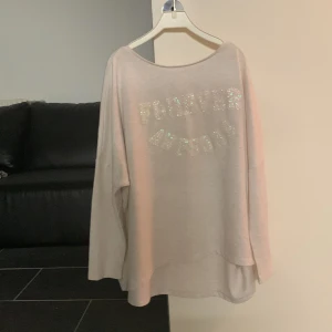 Ljusbeige oversized tröja från H&M - Ljusbeige oversized tröja från H&M med texten 'FOREVER AWESOME' i glittriga bokstäver på framsidan. Tröjan har långa ärmar och en lös, avslappnad passform. Perfekt för en chill och bekväm stil.