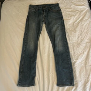 Blå Levi's 514 jeans  - Säljer ett par klassiska blå Levi's 514 jeans med raka ben och normal passform. De är i storlek 30/34. Finns några defekter då byxorna är ganska gamla, defekterna är med på bilderna. Kontakta mig om du har frågor eller funderingar.