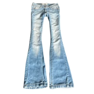 Lågmidjade ljusblå bootcut jeans - Midjemått 37 Innerbenslängd: 77
