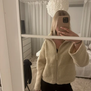 Beige teddyjacka med dragkedja - Mysig beige teddyjacka. Har inte kommit till användning derför jag säljer den. Fin i kvalite, skön i materialet, Har den i storlek S.