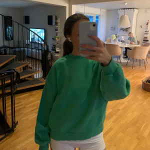 Grön oversized sweatshirt - Enkel och snygg grön sweatshirt med oversized passform och långa ärmar. Tröjan har rund halsringning och breda muddar vid ärmslut och nederkant. Perfekt för en chill och avslappnad stil.