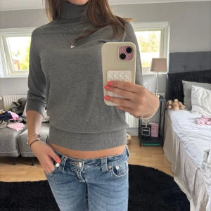 Grå polotröja från Zara - Grå polotröja från Zara med trekvartsärm och ribbade muddar. Perfekt till jeans eller kjol inför sommaren!