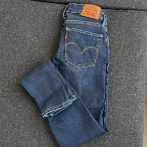 Levis 710 Super Skinny  - Mörkblå, tighta jeans ifrån Levi’s. Storlek W23. Modellen heter ”710 SUPER SKINNY”, midjan är mid-rise (medelhög). Väldigt stretchiga!  Endast använda 2 gånger då de är för små för mig.