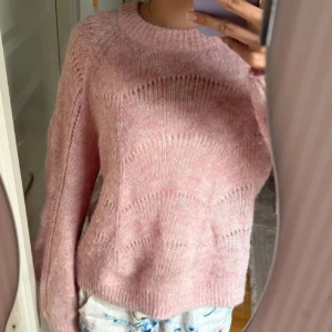 Ljusrosa stickad tröja med mönster - Supermysig ljusrosa stickad tröja med diskret mönster och rund hals. Tröjan har lång ärm och är perfekt för lager på lager. Den är fluffig och har en avslappnad passform som känns både trendig och bekväm. Stor storlek m men sitter som S💕