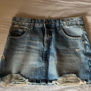 Blå jeanskjol - Super fin jeans kjol med slitningar från pull&bear. Köpte förra sommaren och har endast använts 2-3 gånger😊