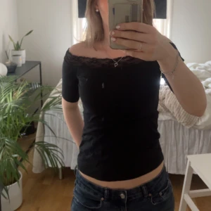 snygg offshoulder topp med spets - Säljer denna svarta offshoulder topp med spets, då den tyvärr inte kommer till användning längre💓 storleken står ej men skulle säga att den passar en xs/s