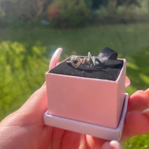 Silverring med hjärta och EKG-motiv - Snygg silverring i äkta 925 silver med ett öppet hjärta och EKG-linje som motiv. Hjärtat är dekorerat med små gnistrande stenar för extra bling. Perfekt för dig som gillar unika och trendiga smycken med cool design.