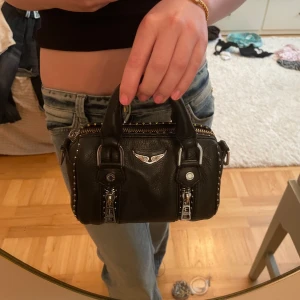Zadig& voltaire sunny nano väska💖 - Superfin väska från Zadig & voltaire i modellen sunny nano!💕Haft ganska länge, men i bra skick. Metallen har tappat lite färg och blivit mer koppar färgad, men skulle inte säga att man tänker på de så mycket💖Axelremsbandet följer såklart också med💖Köpt i Paris💕