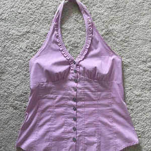 Ljuslila halterneck topp Express S - Superfin ljuslila halterneck topp från Express Design Studio. Toppen har knappar vid nacken som går att justera. Stolen S. 💜