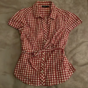 rödvit rutig skjorta från lindex💞 - säljer denna snygga kortärmade skjorta från lindex som jag köpte från second hand då den aldrig kommer till användning! 💗 storleken är 38/m men passar även mig som brukar ha xs-s, priset går att diskutera! 